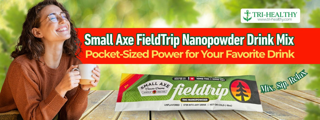 Smiling woman drinking from a mug outdoors next to a product banner for Small Axe FieldTrip Nanopowder Drink Mix